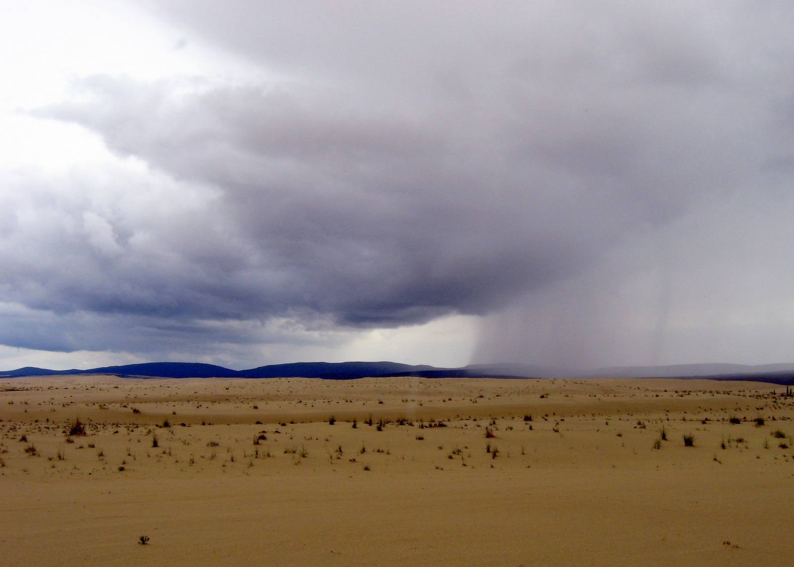 Storm clouds release a sheet of rain in the distance. A Flood Watch covers the Wood River Valley through 6 p.m. Monday. (File photo.)